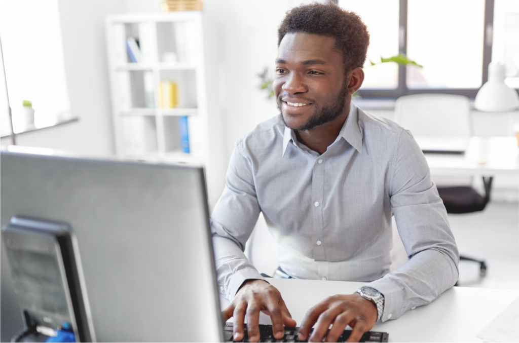 man typing on computer